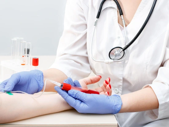 Doctor extracting blood from patient for blood testing.