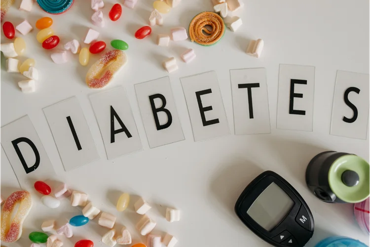 Diabetes concept with glucometer and sugary snacks illustrating high blood sugar and its causes.