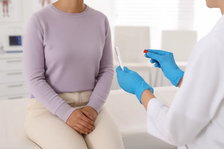 Doctor preparing genital swab test kit for lymphogranuloma venereum (LGV) testing in clinic.