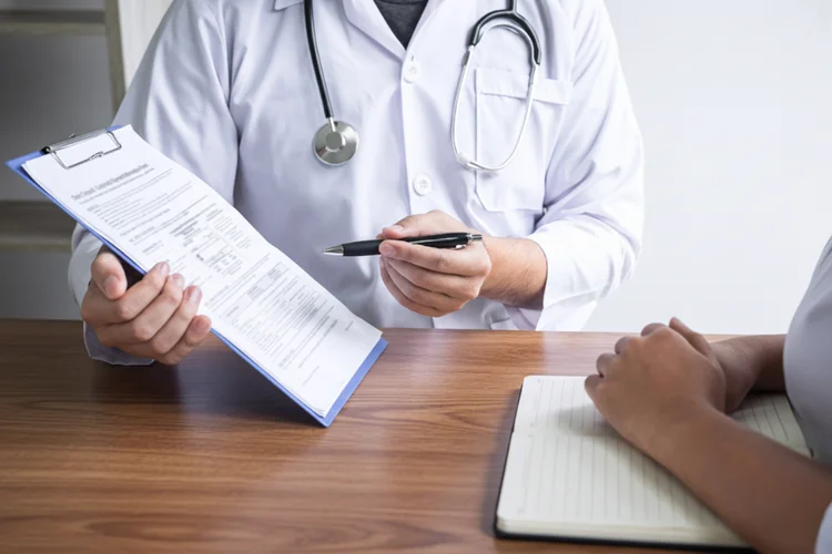 Doctor reviewing patient blood pressure results and discussing lifestyle factors affecting readings.