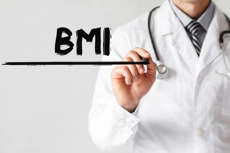 Doctor using a marker to write BMI on a clear panel.