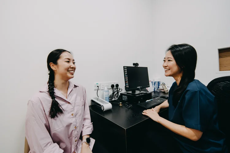 Dr Jana Lim from ATA Medical Tanjong Pagar Clinic speaking with a patient during a friendly clinic consultation.