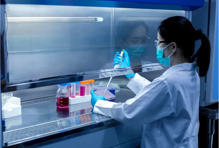 Laboratory technician analysing stool sample to evaluate gut microbiome using DNA sequencing.