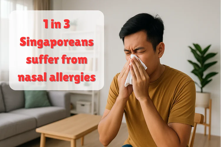 Young man sneezing at home due to nasal allergies, which affect one in three people in Singapore.